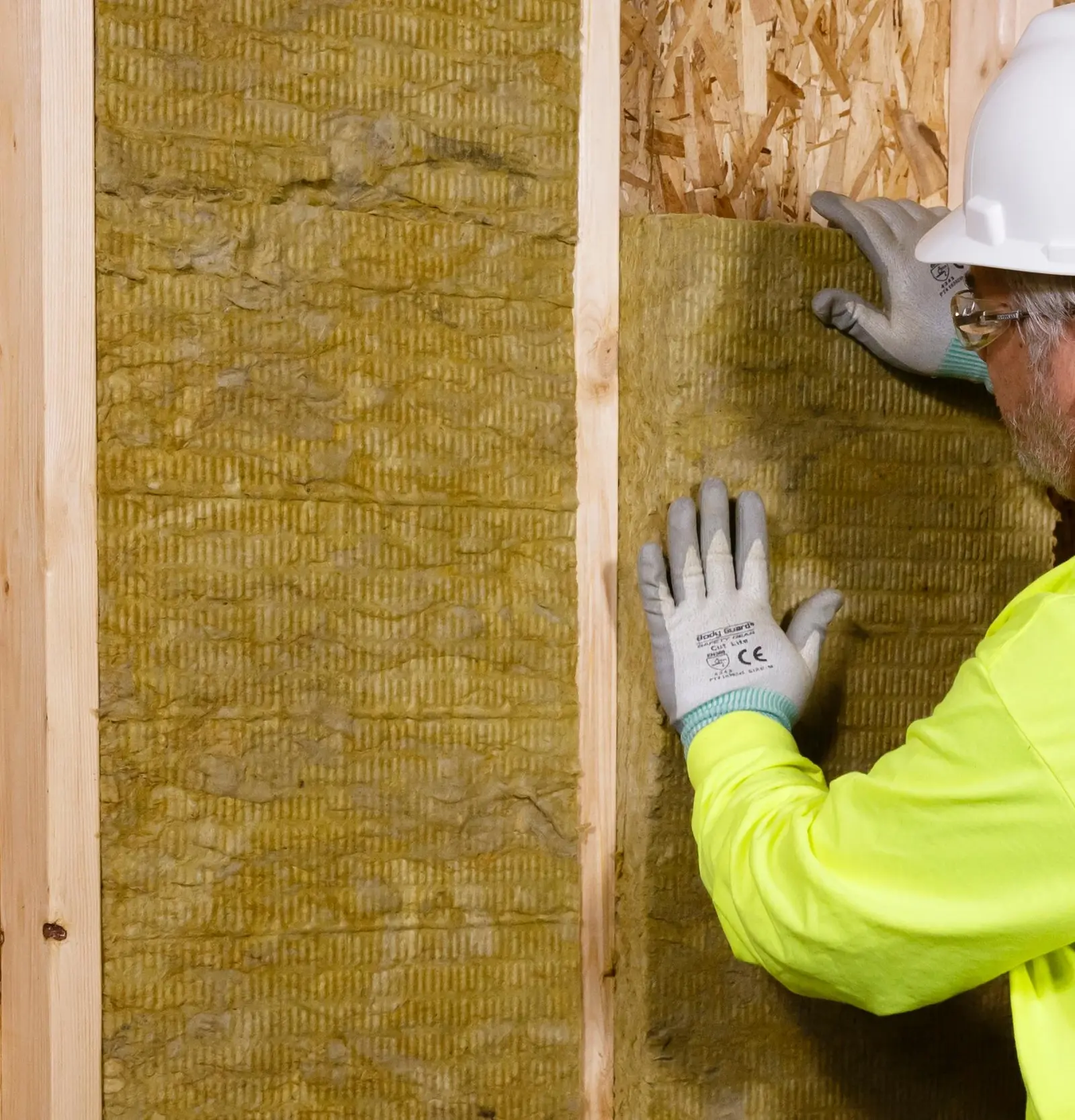Mineral-wool batts friction-fitted in a framed partition wall