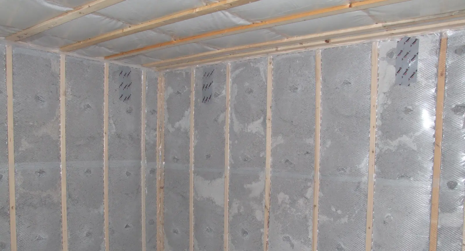 Sheeting installed over insulated stud walls and ceiling