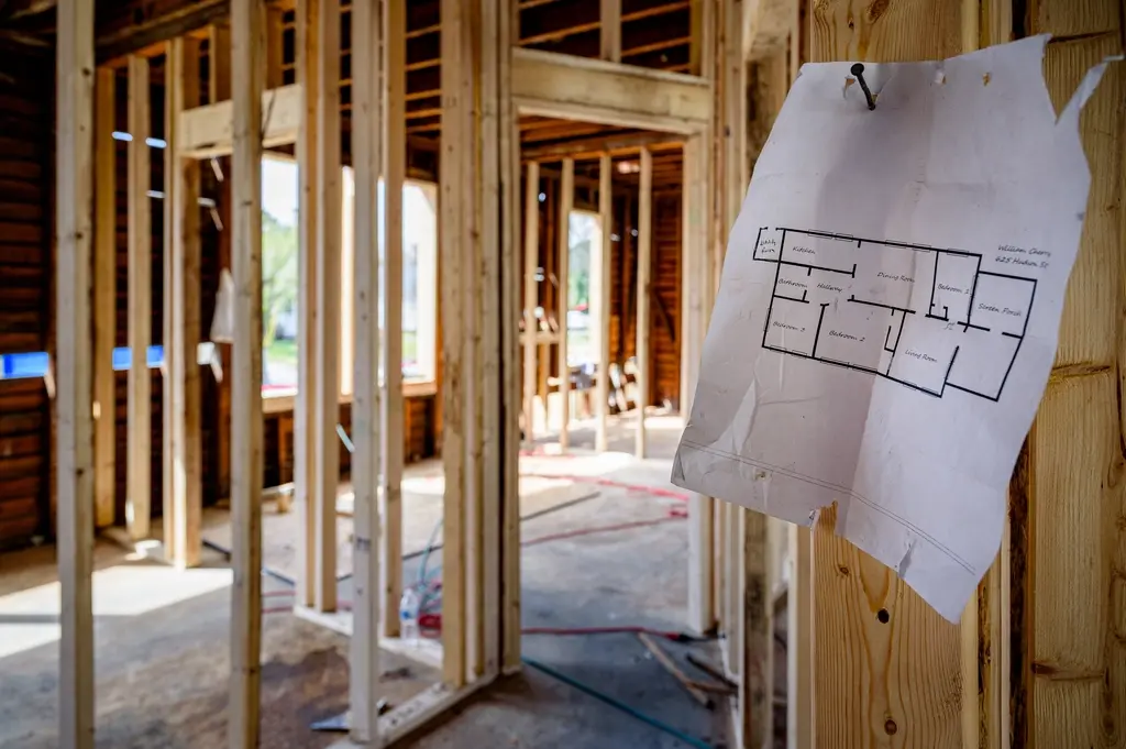 Interior stud walls with a floor plan pinned to the framing